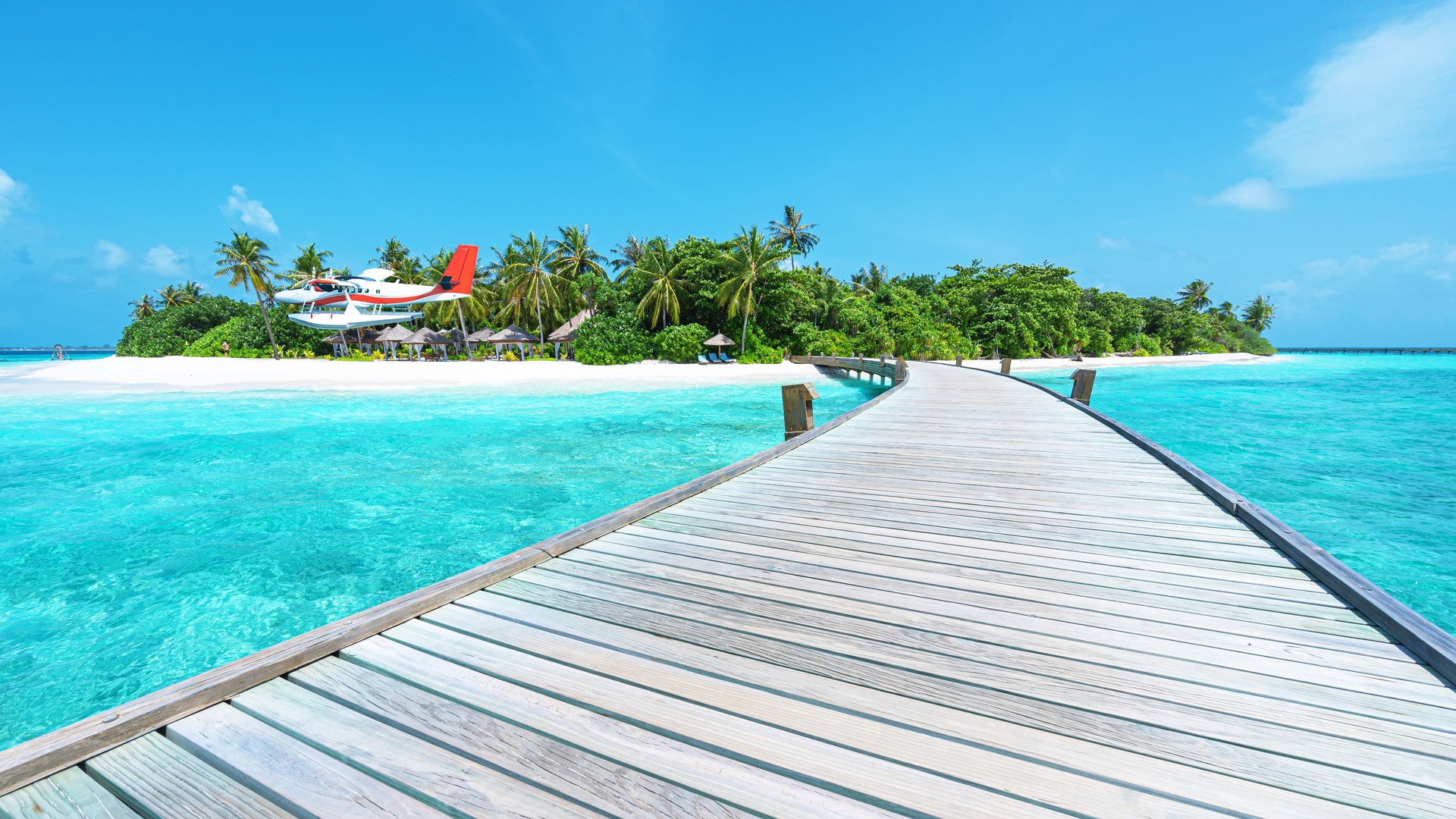 Seaplane arriving at the tropical paradise beach resort -- Tropical beach holidays and luxury travel concept